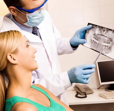 Dentist reviewing dental X-rays with patient in Paradise Valley office.