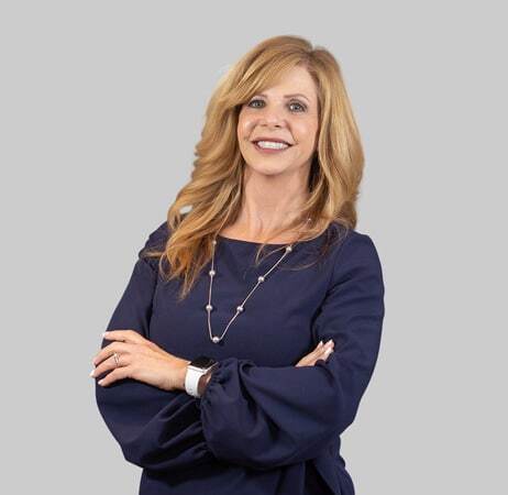 Sharon, dental professional at Paradise Valley, AZ practice, smiling with arms crossed.