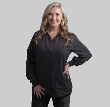 Professional female dental team member smiling in black shirt at Paradise Valley dental practice.