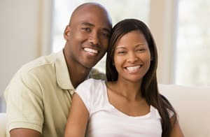 Smiling couple posing together indoors at Paradise Valley dental practice.