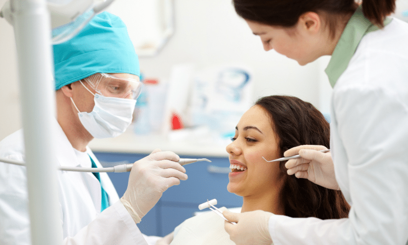 Dentist and assistant examining patient's teeth during cosmetic dental treatment in Paradise Valley.