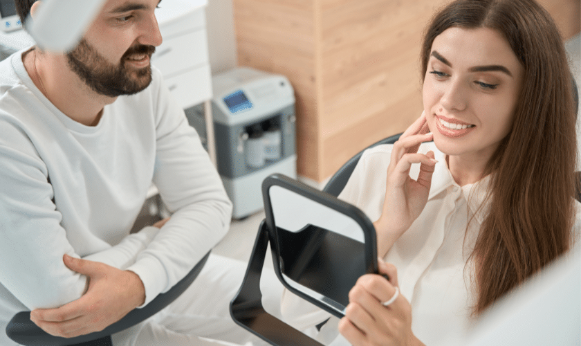 Female patient smiling while dentist discusses preventive dental care in Paradise Valley office.