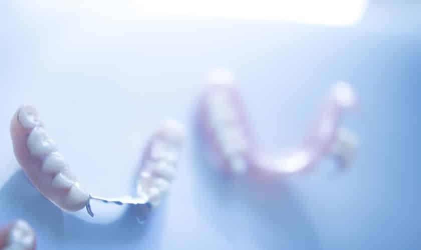 Close-up of dental implant-retained denture showing natural-looking teeth structure.