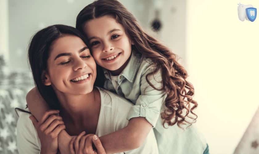 Happy mother and daughter smiling together for Mother's Day dental wellness celebration.