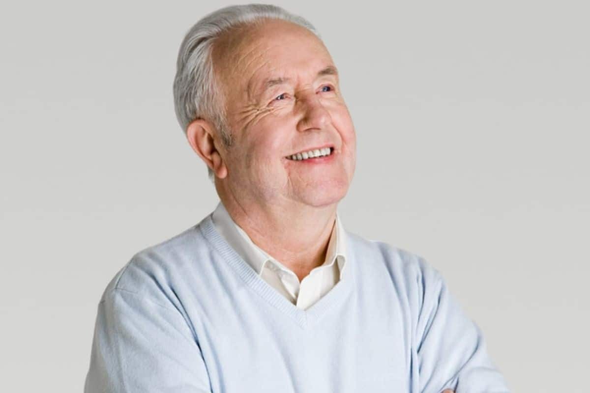 Senior man smiling with natural-looking dentures in Paradise Valley dental practice.