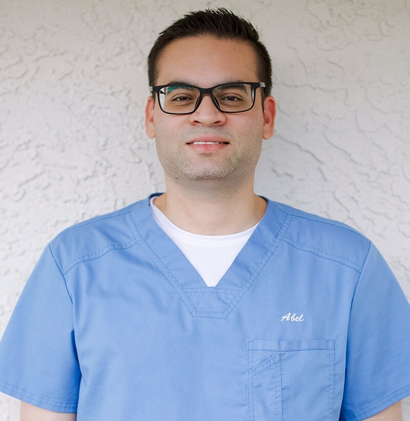 Abel Perez, dental professional in blue scrubs at Paradise Valley dental practice.