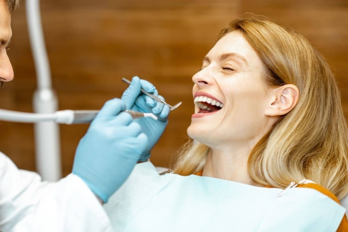 Dentist examining patient's teeth during professional cleaning appointment in Paradise Valley.