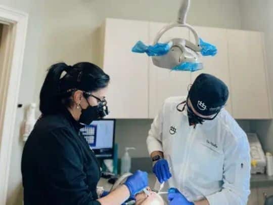 Dentist applying dental sealants to patient's teeth in Paradise Valley dental office.