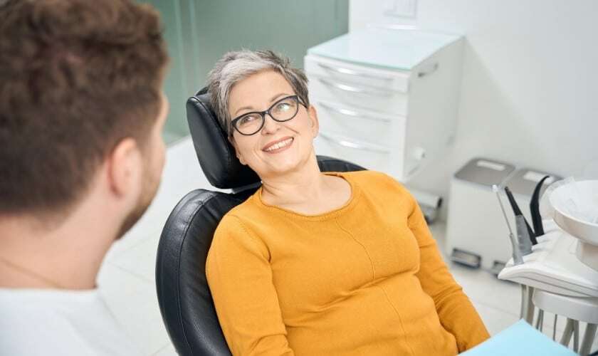 Smiling woman in dental chair during consultation with dentist in Paradise Valley.